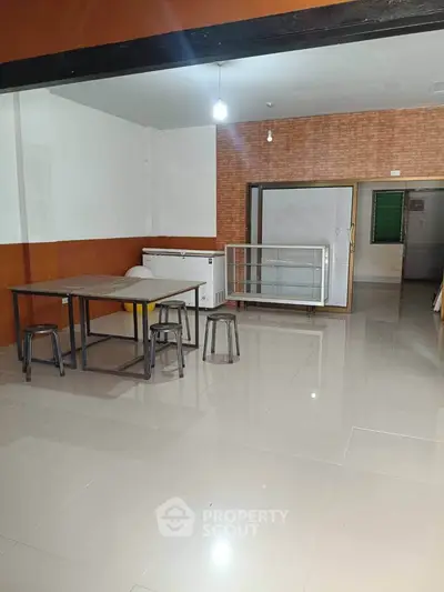 Spacious open-plan room with modern furniture and tiled flooring