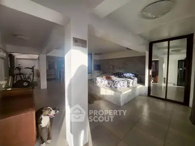 Spacious modern bedroom with stylish decor and ample natural light