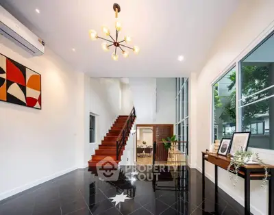 Spacious modern living room with elegant staircase and stylish decor