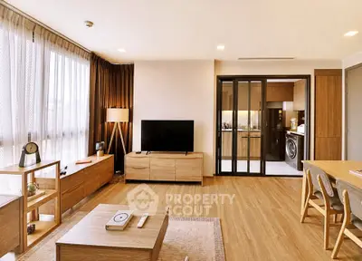 Spacious modern living room with wooden flooring and open kitchen layout