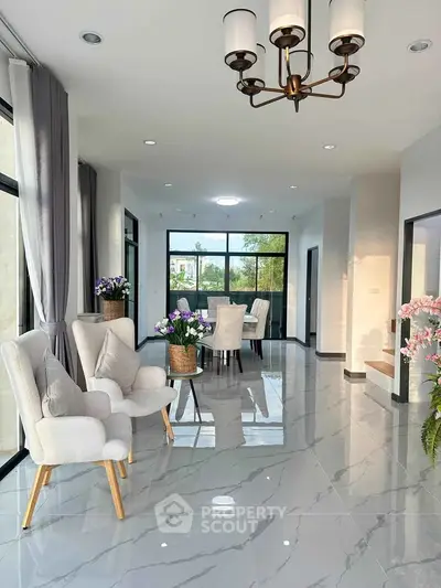 Elegant living room with modern decor and large windows offering natural light.