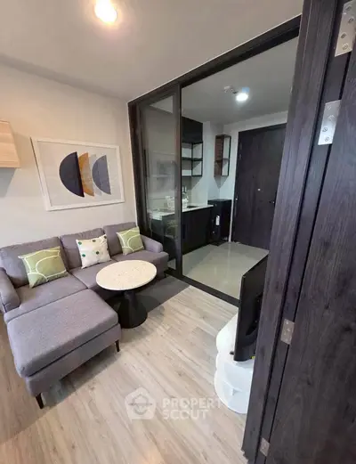 Modern living room with cozy sectional sofa and stylish decor in open layout apartment.
