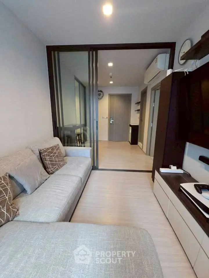 Modern living room with sleek design and cozy ambiance in a stylish apartment.