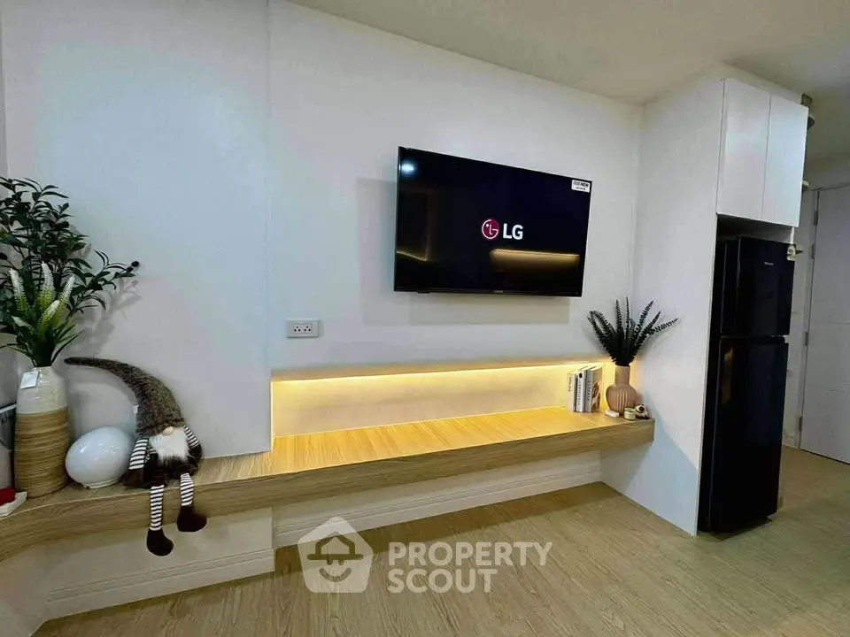 Modern living room with wall-mounted TV and sleek wooden shelving