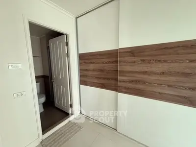 Modern interior with sliding closet doors and bathroom entrance