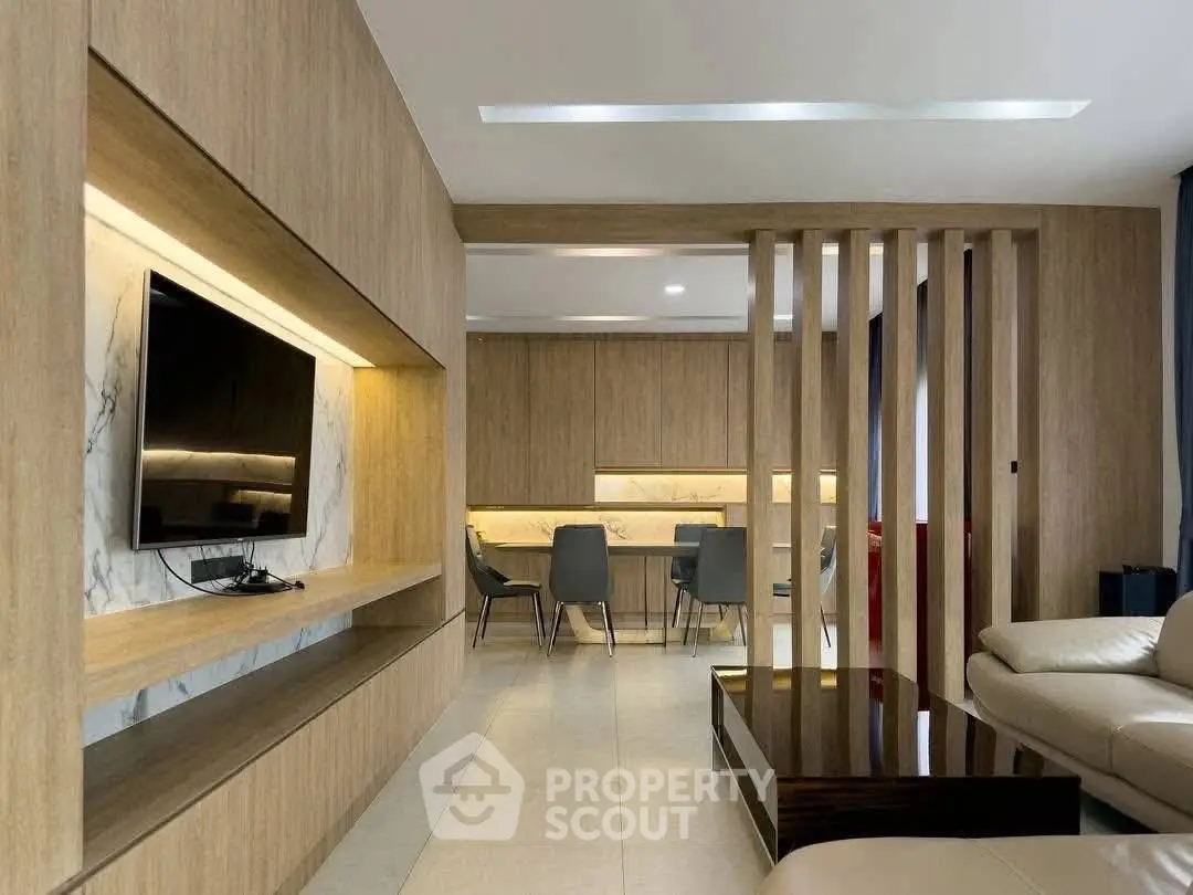 Modern living room with sleek wooden paneling and integrated TV unit