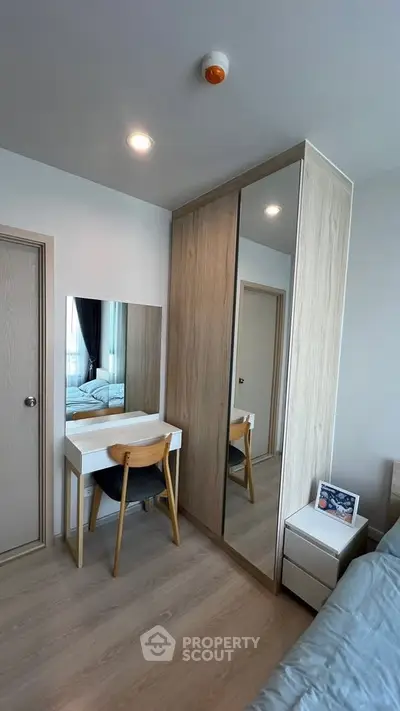 Modern bedroom with sleek wardrobe and stylish vanity set