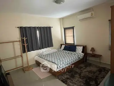 Cozy bedroom with modern decor and air conditioning