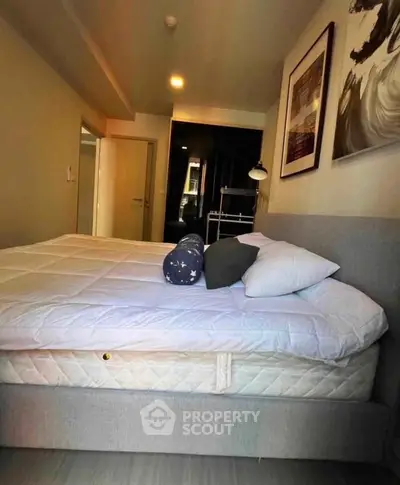 Cozy bedroom with modern decor and comfortable bedding in a stylish apartment.