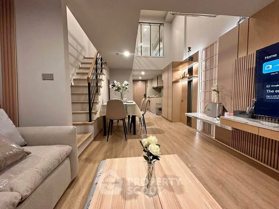 Modern duplex living room with stylish decor and open kitchen layout