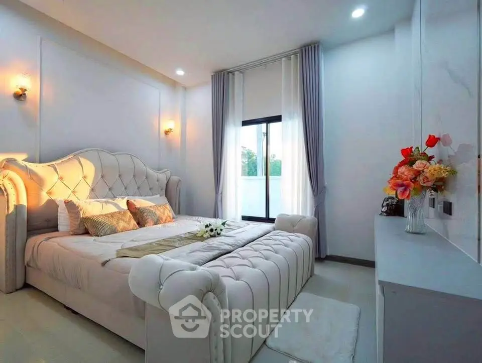 Luxurious bedroom with elegant decor and plush bedding in a modern home.