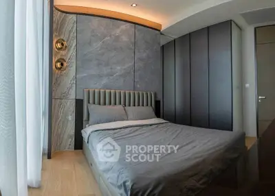 Luxurious modern bedroom with elegant design and stylish lighting fixtures.