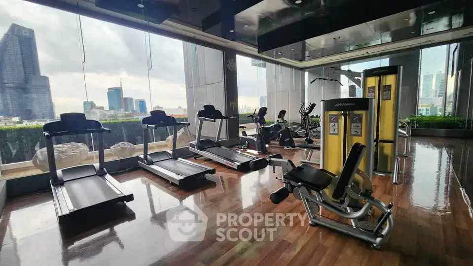 Luxurious high-rise gym with modern equipment and stunning city views.