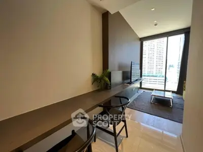 Modern living room with sleek furniture and large window offering city view.