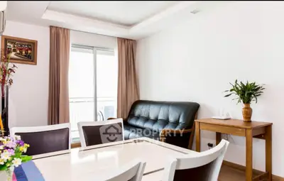 Bright living room with dining area and sliding glass doors to balcony