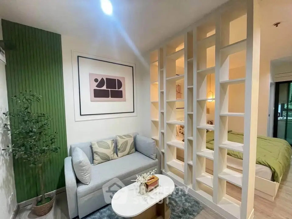 Modern living room with stylish partition leading to cozy bedroom, featuring elegant decor and comfortable seating.