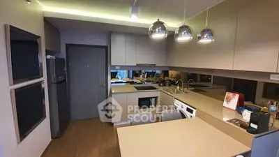 Modern kitchen with sleek cabinetry and built-in appliances in a stylish apartment.