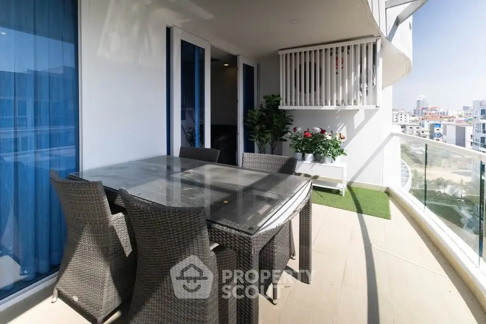 Spacious balcony with outdoor dining set and city view, perfect for entertaining.