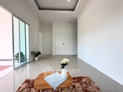Spacious minimalist living room with modern decor and large windows