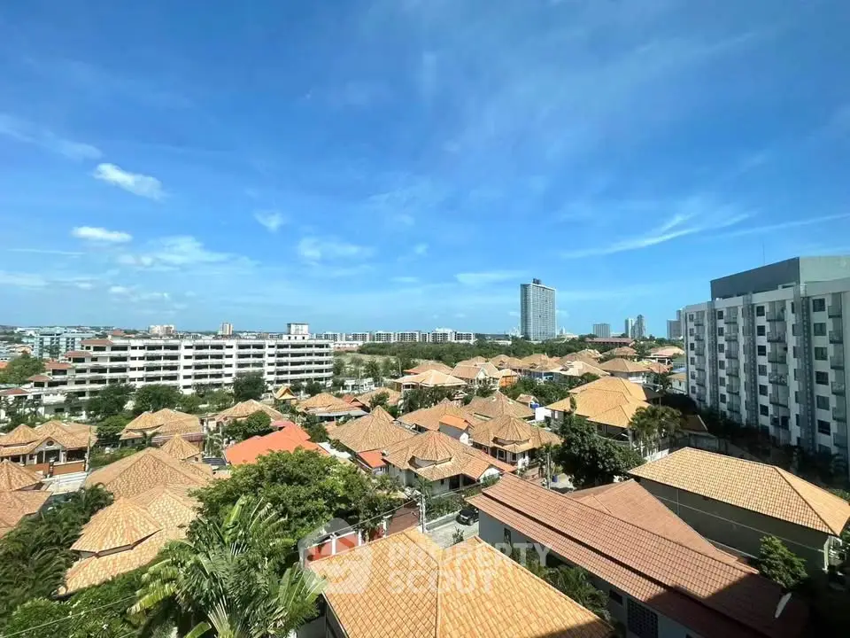 Stunning aerial view of residential neighborhood with modern high-rise buildings and clear blue sky.