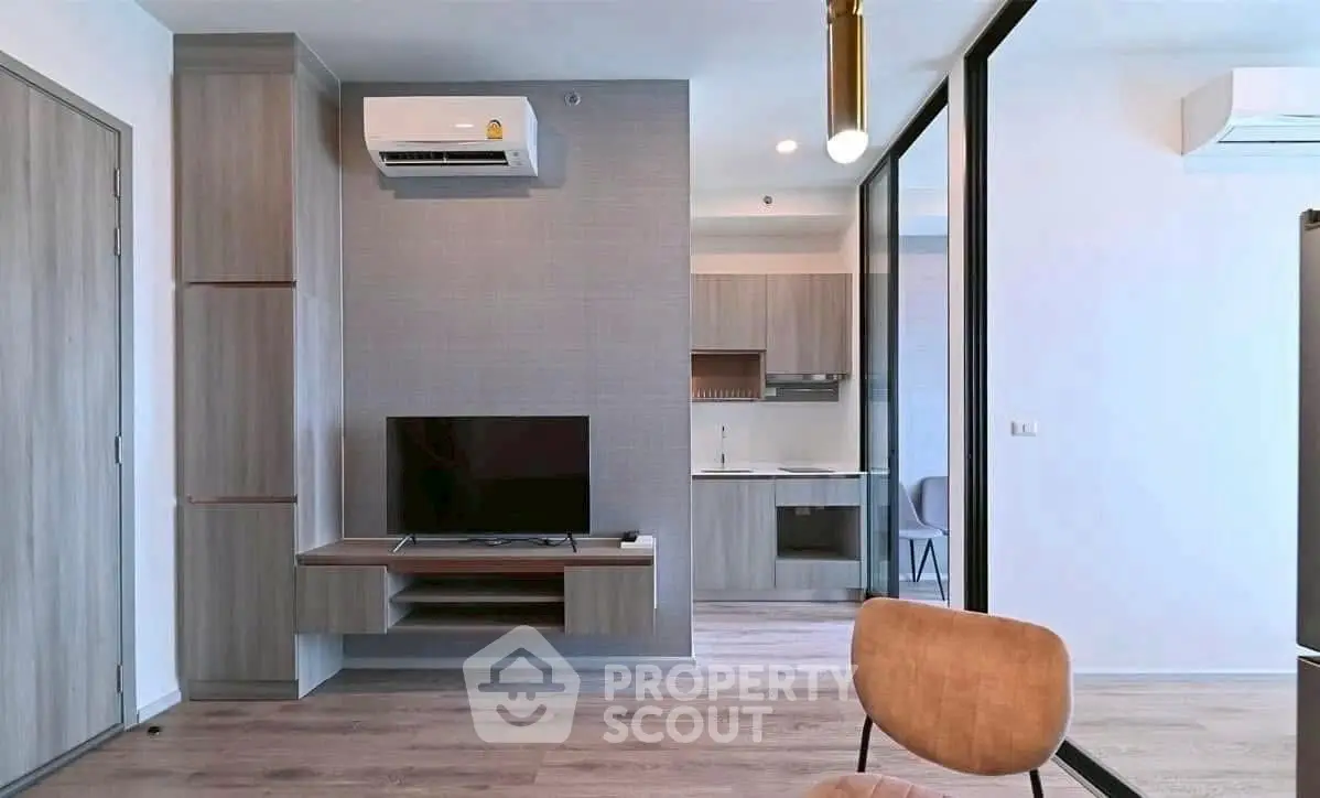 Modern living room with sleek design and integrated kitchen area