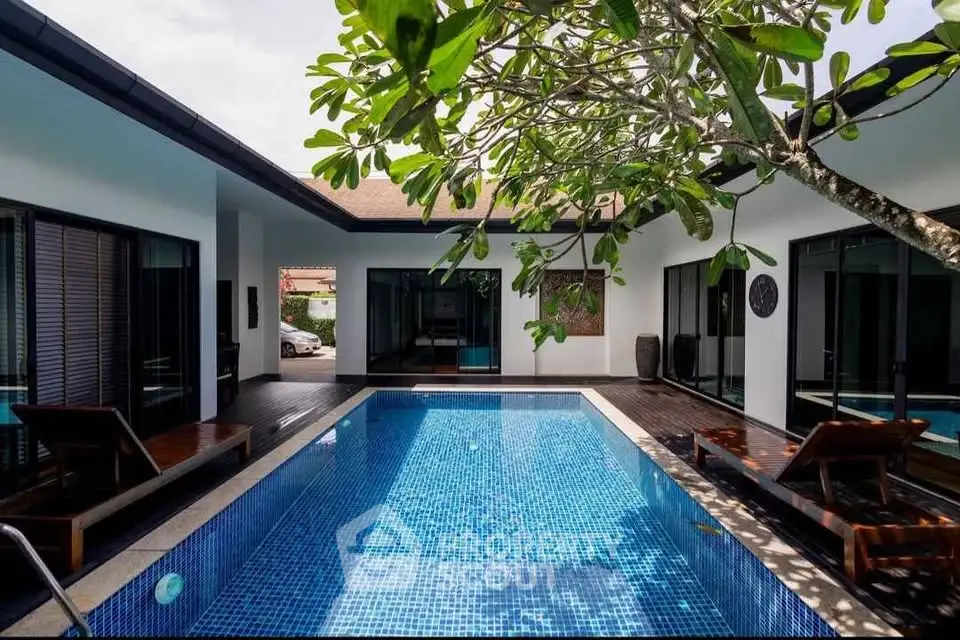 Luxurious villa with private pool and sun loungers, perfect for relaxation and entertainment.