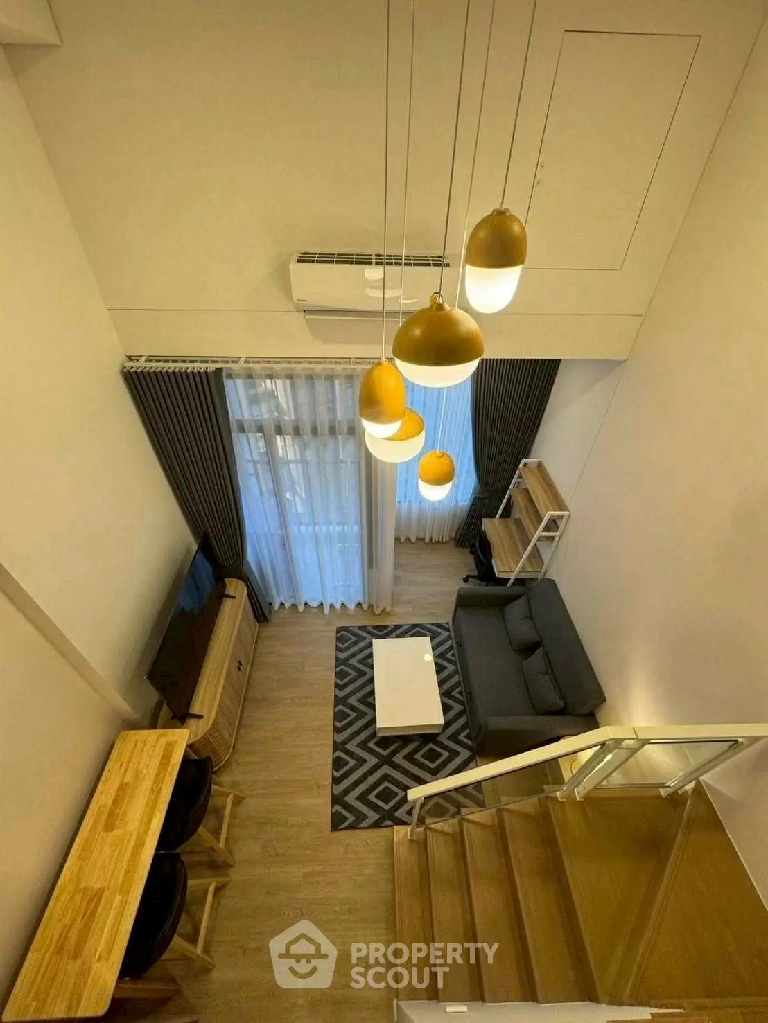 Modern loft-style living room with high ceiling and stylish lighting