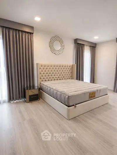 Luxurious bedroom with elegant tufted bed and modern decor