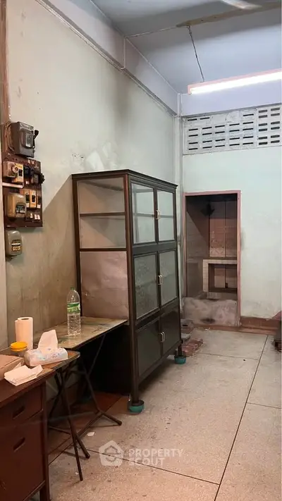 Industrial-style storage room with metal cabinet and utility area