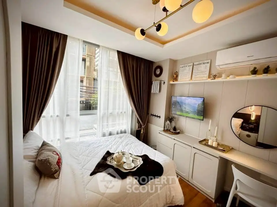 Cozy bedroom with modern decor, featuring a comfortable bed, stylish lighting, and a wall-mounted TV.
