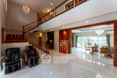Luxurious open-plan living room with elegant staircase and dining area