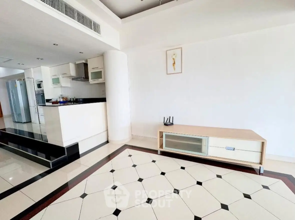 Spacious modern living room with open kitchen and stylish flooring in luxury apartment.