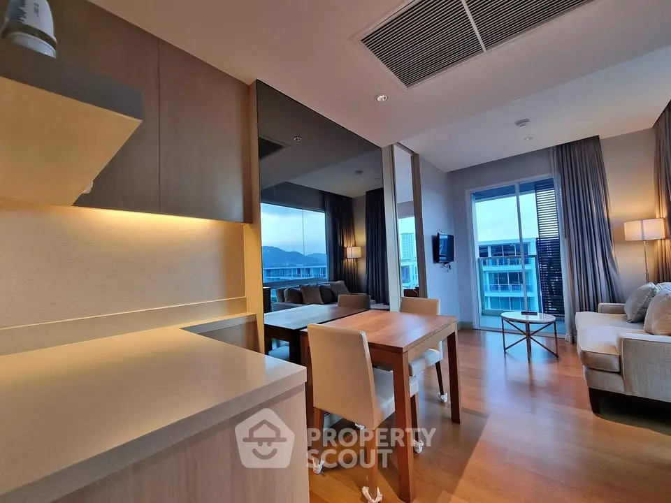 Modern open-plan living room with dining area and scenic balcony view
