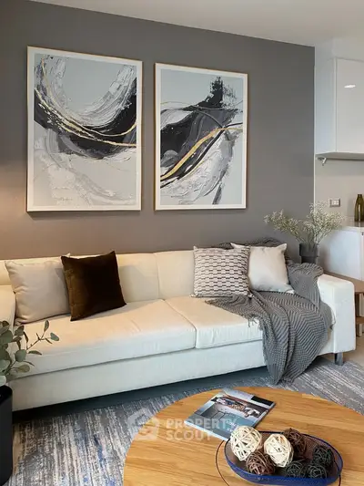 Modern living room with stylish decor and abstract art on the wall.