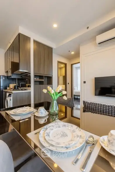 Modern dining area with elegant table setting in a stylish apartment interior.
