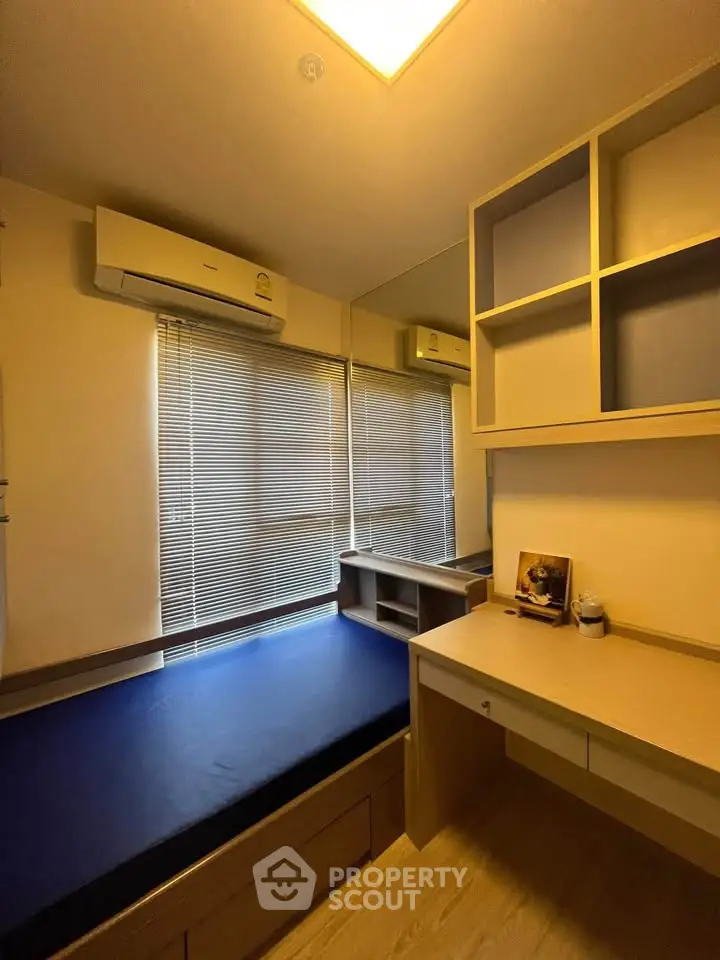 Cozy bedroom with built-in desk and storage, featuring natural light and modern design.