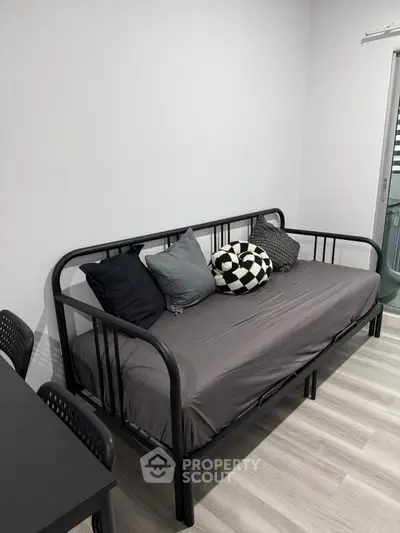 Modern minimalist living room with sleek black daybed and stylish decor