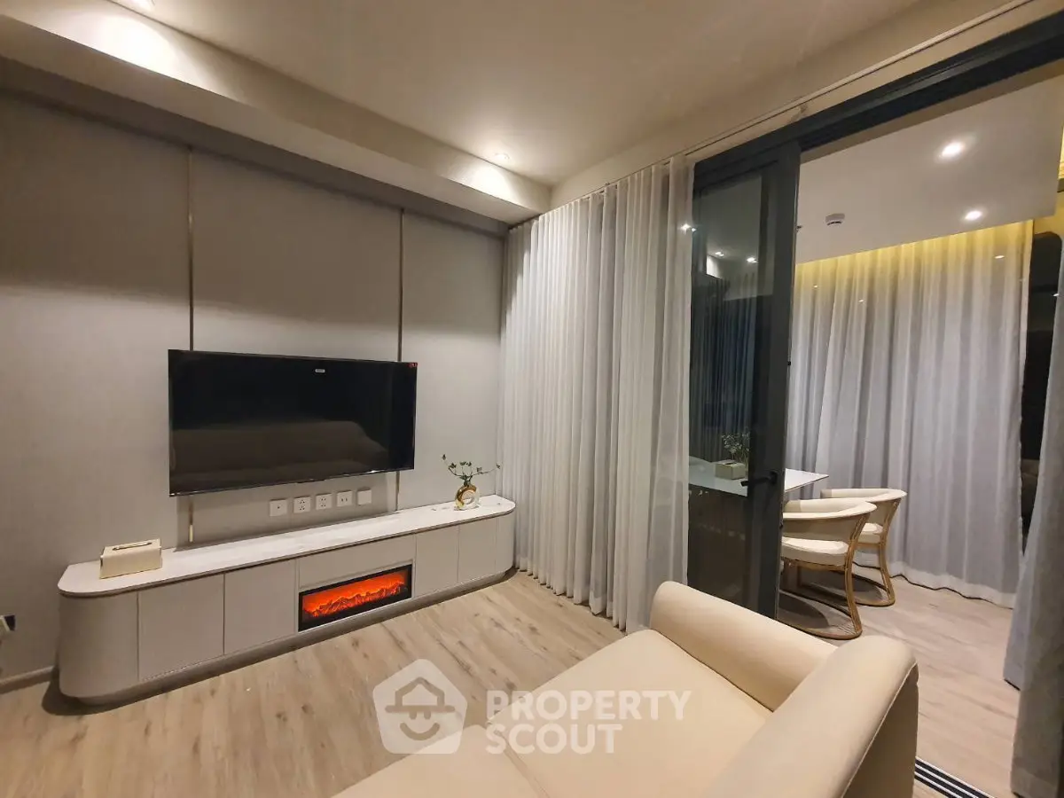 Modern living room with sleek TV setup and cozy balcony view
