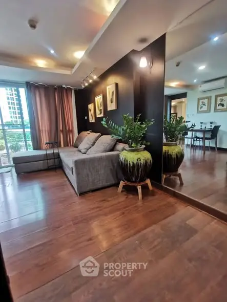 Stylish living room with modern decor and large windows offering natural light and city views.