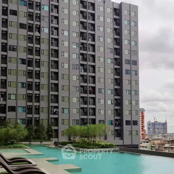 Modern high-rise building with luxurious pool and lush greenery