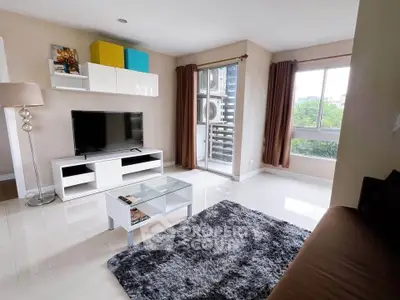 Modern living room with sleek furniture and large windows offering natural light and greenery views.
