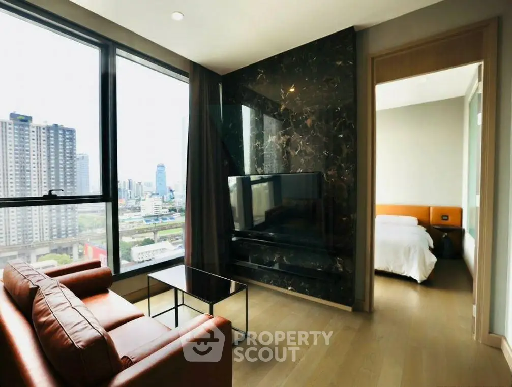 Modern living room with city view and adjacent bedroom in luxury apartment