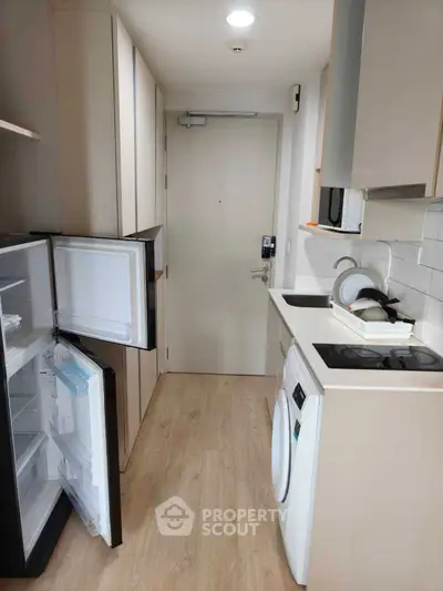 Compact modern kitchen with appliances and wooden flooring