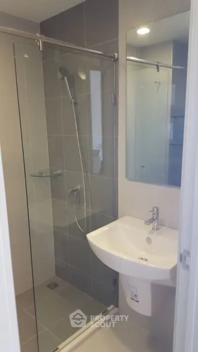Modern bathroom with glass shower enclosure and sleek sink design