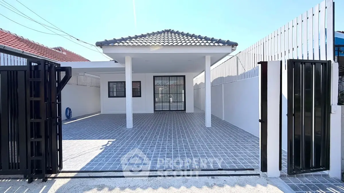 Charming single-story home with tiled driveway and modern gate, perfect for cozy living.