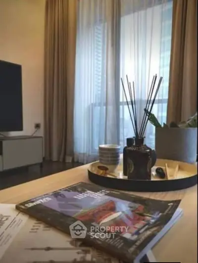 Stylish modern living room with elegant decor and large window view.