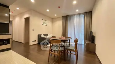 Modern living room with dining area and cozy sofa in a stylish apartment.