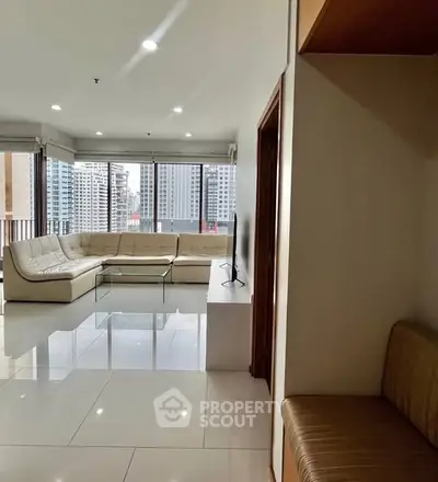 Spacious modern living room with city view and elegant white sofa
