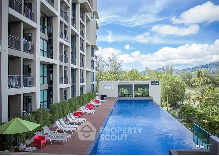 Luxurious condominium with stunning poolside view and lush greenery, perfect for relaxation and leisure.