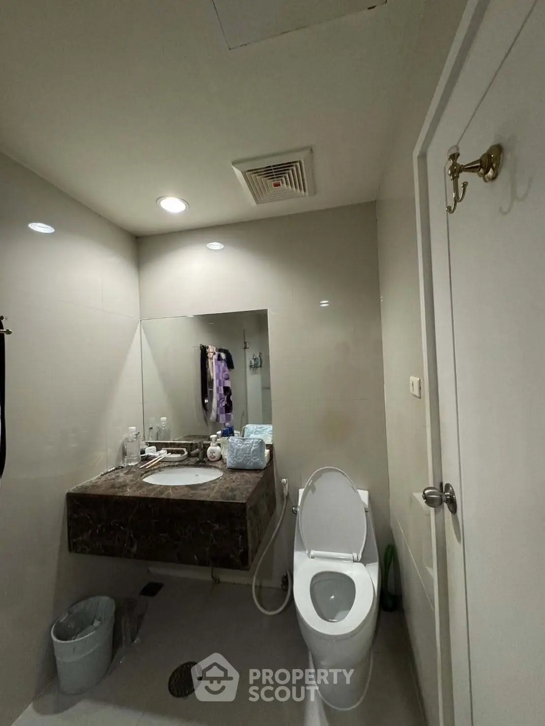 Modern bathroom with sleek design and marble countertop in a contemporary home.